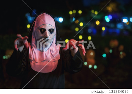 Scary woman in devilish nun mask and dress with fear hand gesture Scary woman in devilish nun mask and dress with fear hand gesture 131284053