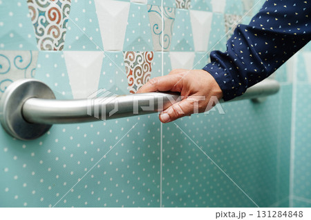Asian woman patient use toilet support rail in bathroom, handrail safety grab bar, security in nursing hospital. Asian woman patient use toilet support rail in bathroom, handrail safety grab bar, security in nursing hospital. 131284848
