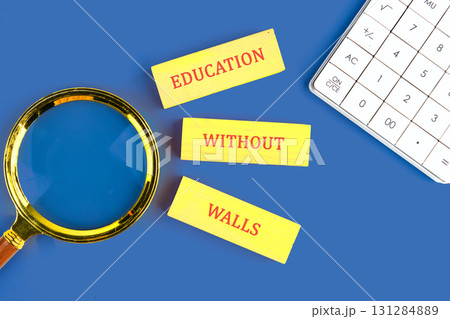 Copy space; Concept words EDUCATION WITHOUT WALLS made of wooden blocks on blue background next to calculator, top view 131284889