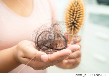 Asian woman have problem with long hair loss attach in her hand. 131285197