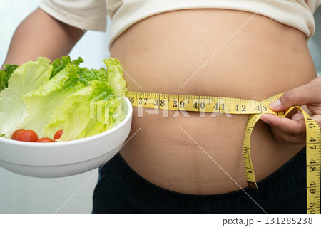 Asian woman with fat belly big size overweight and obesity with healthy food. Asian woman with fat belly big size overweight and obesity with healthy food. 131285238