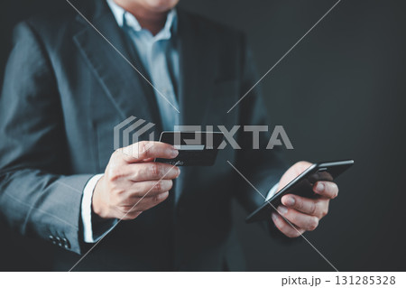 businessman hold credit card and use smartphone to buy or purchase produce payment online. The concept of finance and online shopping. businessman hold credit card and use smartphone to buy or purchase produce payment online. The concept of finance and online shopping. 131285328