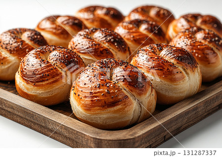Homemade buns. Variety of baked buns in on a wooden trading tray on a white background. 131287337