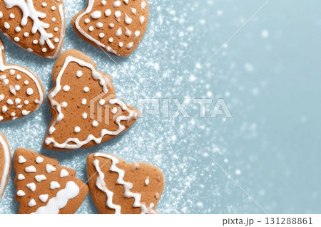 Christmas card with gingerbread cookies over blue background. Top view flat lay with space for xmas greetings 131288861