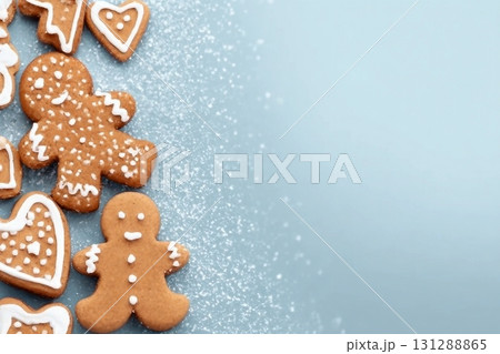 Christmas card with gingerbread cookies over blue background. Top view flat lay with space for xmas greetings 131288865