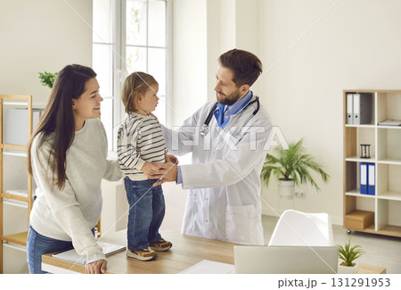 Mother and her little child visiting their family doctor or pediatrician at the clinic Mother and her little child visiting their family doctor or pediatrician at the clinic 131291953
