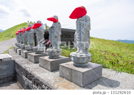 Omuro mountain in Ito, Shizuoka, Japan, Row of stone Jizo statues wearing red hats on hillside path in Japan Omuro mountain in Ito, Shizuoka, Japan, Row of stone Jizo statues wearing red hats on hillside path in Japan 131292610