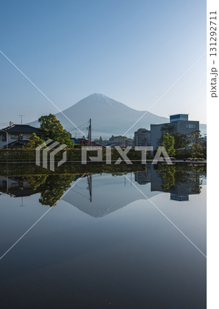 Mount Fuji reflected in water with buildings and trees in foreground at Fujinomiya, Shizuoka, Japan, Mount Fuji reflected in water with buildings and trees in foreground at Fujinomiya, Shizuoka, Japan, 131292711