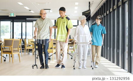 高齢者の歩行サポートをするアジア人介護士 131292956