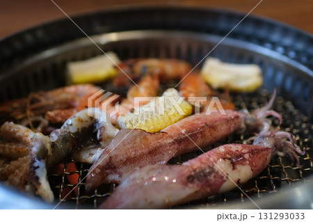 Grilled Seafood Feast on Outdoor Barbecue with Shellfish and Vegetables Grilled Seafood Feast on Outdoor Barbecue with Shellfish and Vegetables 131293033