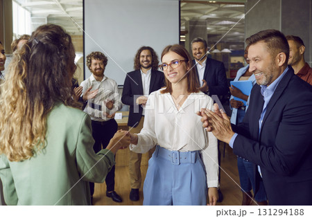 Business colleagues congratulating each other on business achievements and excellent results at work 131294188