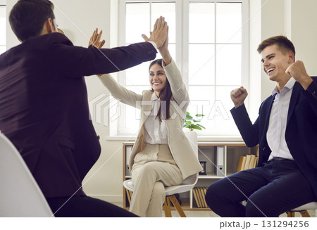 Team of happy people celebrate successful business deal after negotiation meeting Team of happy people celebrate successful business deal after negotiation meeting 131294256