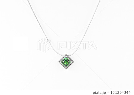 A green square gemstone pendant with a white chain A green square gemstone pendant with a white chain 131294344