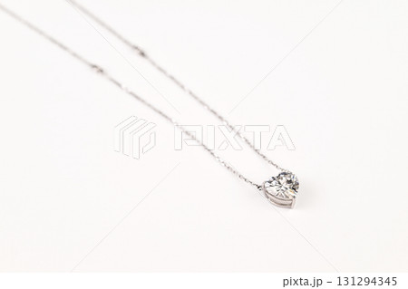 A silver necklace with a heart shaped diamond pendant A silver necklace with a heart shaped diamond pendant 131294345