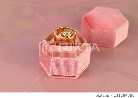 A ring is in a pink velvet box 131294389