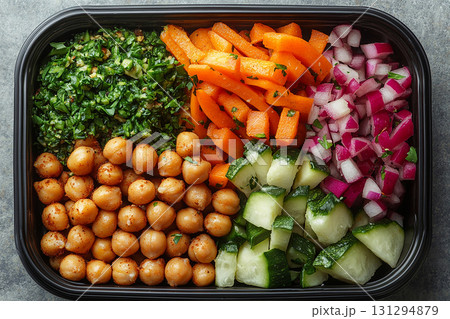 Plant based lunch box with hummus, roasted chickpeas, fresh veggie sticks and whole wheat pita bread on. Plant based lunch box with hummus, roasted chickpeas, fresh veggie sticks and whole wheat pita bread on. 131294879