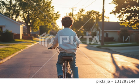 Grainy film-style image of teen cycling down a calm street, evoking 90s vibes with warm light, vintage fashion, and nostalgic tones perfect for lifestyle or editorial use. 131295144