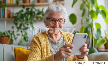 Natural daylight, authentic home interior, and personal digital storytelling. Perfect for modern senior influencer visuals. 131296081