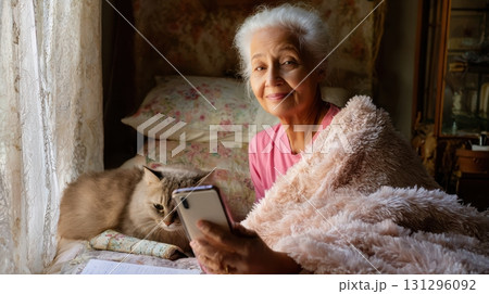 Senior woman shares advice from bed with cat, warm light, and handwritten notes. Ideal for personal vlog or senior lifestyle themes. 131296092