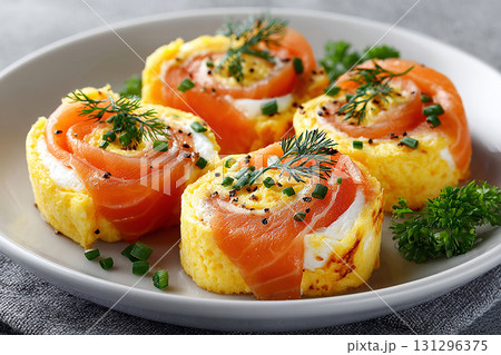 White tableware. Gourmet high-protein breakfast. Premium Hotel breakfast. Breakfast sushi: scrambled eggs and smoked salmon rolls. Viral food trend. 131296375
