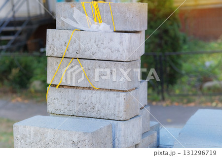 Stacked sidewalk paving stones. Textured and ready for construction. Construction material. Building construction. Gray blocks for roadway. Stacked sidewalk paving stones. Textured and ready for construction. Construction material. Building construction. Gray blocks for roadway. 131296719