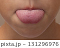 CloseUp of a Child Sticking Out Tongue 131296976
