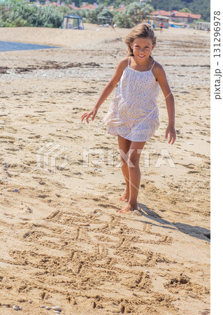 Girl Jumping on Hopscotch Drawn in the Sand Girl Jumping on Hopscotch Drawn in the Sand 131296978