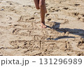 Childs Legs Jumping on Hopscotch in the Sand 131296989