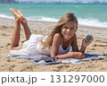 Smiling Child Showing Painted Stone on Beach 131297000