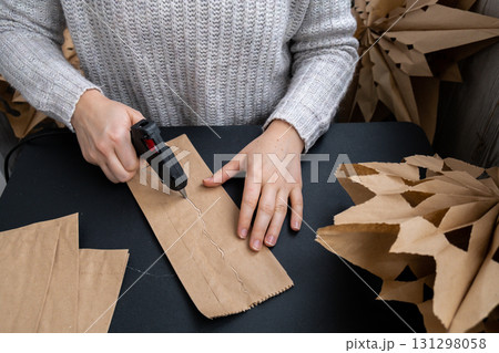 Master class of making craft paper snowflakes for conscientious Christmas decor. Sustainable celebration minimal responsible DIY holiday project. Step by step Master class of making craft paper snowflakes for conscientious Christmas decor. Sustainable celebration minimal responsible DIY holiday project. Step by step 131298058
