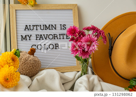 Letter board with text AUTUMN IS MY FAVORITE COLOR Fall Bouquet for Thanksgiving holiday. Seasonal Warm colorful blossom flowers arrangement festive decoration. Selective 131298062