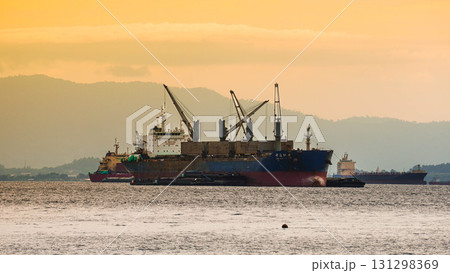 Cargo ship at sea during sunset. 131298369