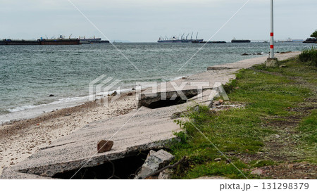 Coastal road destruction by storm waves. Coastal road destruction by storm waves. 131298379