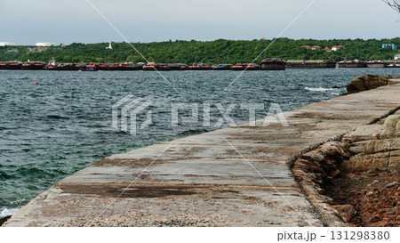 Concrete pier extending into ocean. 131298380