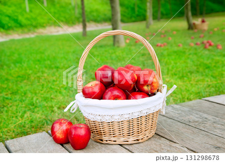 basket of red apples on wood floor basket of red apples on wood floor 131298678