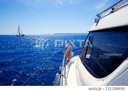 boat side view of blue ocean with sailboat 131298698