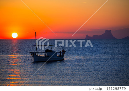 Ibiza sunset Es Vedra view and fisherboat formentera 131298779