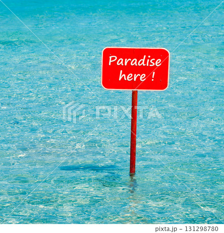 turquoise tropical sea with red sign saying Paradise here turquoise tropical sea with red sign saying Paradise here 131298780