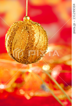 Christmas card of golden bauble and red blur 131299384