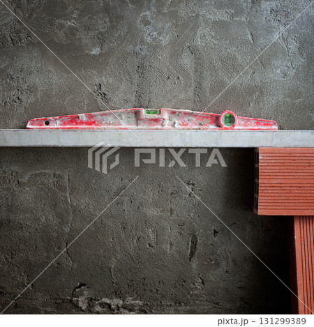 bubble spirit level tool in red on costruction cement bubble spirit level tool in red on costruction cement 131299389