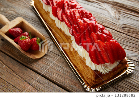 Strawberries puff pastry pie on wood 131299592