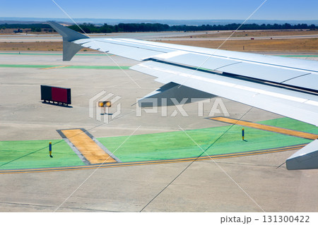 Airplane wing leaving the airport 131300422