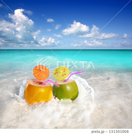 coconut cocktails juice in tropical beach water splash coconut cocktails juice in tropical beach water splash 131301008