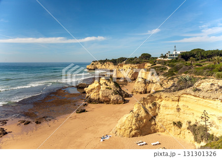 Stunning image of Algarve iconic cliffs of Seven Hanging Valleys and golden sandy beach. Serene shoreline, set against the clear blue ocean, capturing Portugal natural beauty 131301326