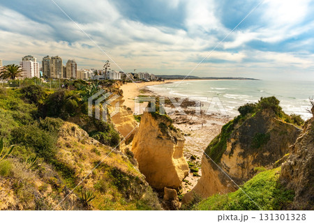 Stunning image of Algarve iconic cliffs of Seven Hanging Valleys and golden sandy beach. Serene shoreline, set against the clear blue ocean, capturing Portugal natural beauty 131301328