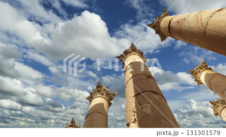 Roman Columns in the Jordanian city of Jerash (Gerasa of Antiquity), capital and largest city of Jerash Governorate, Jordan. Against the background of a beautiful sky with clouds Roman Columns in the Jordanian city of Jerash (Gerasa of Antiquity), capital and largest city of Jerash Governorate, Jordan. Against the background of a beautiful sky with clouds 131301579