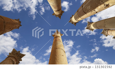 Roman Columns in the Jordanian city of Jerash (Gerasa of Antiquity), capital and largest city of Jerash Governorate, Jordan. Against the background of a beautiful sky with clouds 131301592