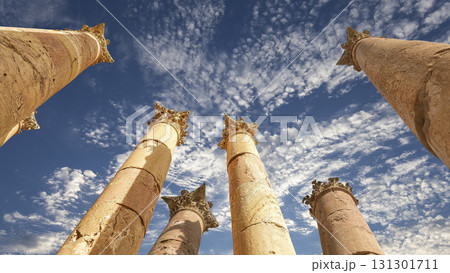 Roman Columns in the Jordanian city of Jerash (Gerasa of Antiquity), capital and largest city of Jerash Governorate, Jordan. Against the background of a beautiful sky with clouds 131301711