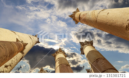 Roman Columns in the Jordanian city of Jerash (Gerasa of Antiquity), capital and largest city of Jerash Governorate, Jordan. Against the background of a beautiful sky with clouds Roman Columns in the Jordanian city of Jerash (Gerasa of Antiquity), capital and largest city of Jerash Governorate, Jordan. Against the background of a beautiful sky with clouds 131301721