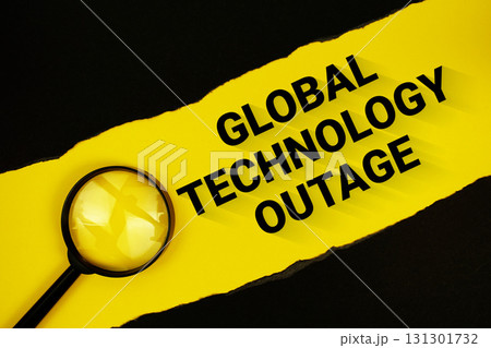 Global Technology Outage text on yellow with black paper torn ripped and magnifying glass 131301732